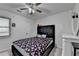 Well-lit bedroom featuring a queen bed, a dresser, and a window at 1358 Millstream Trl, Lawrenceville, GA 30044