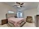 Large primary bedroom with a fan, reading nook, and dresser at 1358 Millstream Trl, Lawrenceville, GA 30044