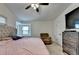 Relaxing bedroom featuring a cozy recliner, a bay window seat, and soft natural light at 1358 Millstream Trl, Lawrenceville, GA 30044