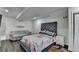 Bright bedroom featuring a large bed, a loveseat, and a window at 1358 Millstream Trl, Lawrenceville, GA 30044