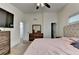 Spacious primary bedroom with a ceiling fan, and ensuite bathroom at 1358 Millstream Trl, Lawrenceville, GA 30044