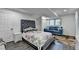 Cozy bedroom with a large bed, a blue sofa and natural light from the window at 1358 Millstream Trl, Lawrenceville, GA 30044