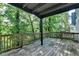 Inviting outdoor deck features a wooden railing and a serene view of the lush surrounding trees at 1358 Millstream Trl, Lawrenceville, GA 30044