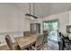 Elegant dining room with modern lighting, seating for six, and slider to deck at 1358 Millstream Trl, Lawrenceville, GA 30044