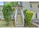 Inviting staircase with gray door and beautifully manicured bushes leading up to the entrance at 1358 Millstream Trl, Lawrenceville, GA 30044