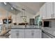 Open-concept kitchen with granite countertops, stainless steel appliances, and hardwood floors at 1358 Millstream Trl, Lawrenceville, GA 30044