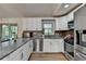 Well-lit kitchen with stainless steel appliances, granite countertops, and stylish backsplash at 1358 Millstream Trl, Lawrenceville, GA 30044