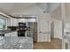 Open kitchen featuring granite countertops, stainless steel appliances, and hardwood floors at 1358 Millstream Trl, Lawrenceville, GA 30044
