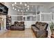 Spacious living room with stone fireplace, hardwood floors, and modern chandelier at 1358 Millstream Trl, Lawrenceville, GA 30044