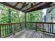 Secluded porch with wooden floors with a lush green background at 1358 Millstream Trl, Lawrenceville, GA 30044