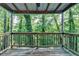 Relaxing porch surrounded by a lush canopy of green trees at 1358 Millstream Trl, Lawrenceville, GA 30044