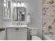 Bathroom featuring a tiled shower-tub, sink with vanity, toilet, and a bright window at 2592 River Oak Dr, Decatur, GA 30033