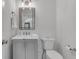 Clean and tidy half bathroom features a gray vanity with marble countertop at 2592 River Oak Dr, Decatur, GA 30033