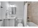 Clean bathroom featuring a shower-tub, sink with vanity, tiled wall, toilet and neutral décor at 2592 River Oak Dr, Decatur, GA 30033