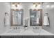 Modern bathroom featuring double sinks, marble countertop, decorative mirrors, and soft, neutral colors at 2592 River Oak Dr, Decatur, GA 30033