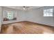 Spacious bedroom boasts hardwood floors, large windows and a window seat with decorative pillows at 2592 River Oak Dr, Decatur, GA 30033