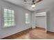 Cozy bedroom with hardwood floors features a ceiling fan and bright, sunlit windows at 2592 River Oak Dr, Decatur, GA 30033