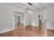 Open dining space with hardwood floors, a modern chandelier, and an adjoining kitchen at 2592 River Oak Dr, Decatur, GA 30033