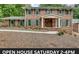 Two-story brick home with green shutters, manicured landscaping, and an inviting covered front porch at 2592 River Oak Dr, Decatur, GA 30033
