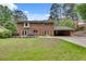 Brick house exterior with lush backyard, patio, and carport for additional covered parking at 2592 River Oak Dr, Decatur, GA 30033