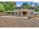 Beautiful brick home with lush landscaping and shuttered windows and inviting entryway at 2592 River Oak Dr, Decatur, GA 30033