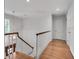 Light and bright upstairs hallway with hardwood floors, white walls, and decorative lighting at 2592 River Oak Dr, Decatur, GA 30033
