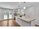 Well-lit kitchen boasts a granite island, stainless steel fridge, and direct access to the backyard at 2592 River Oak Dr, Decatur, GA 30033