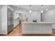 Spacious kitchen with a large central island, stainless steel refrigerator, and hardwood floors at 2592 River Oak Dr, Decatur, GA 30033