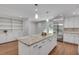 Bright, updated kitchen features a large island, stainless appliances and custom cabinets and shelving at 2592 River Oak Dr, Decatur, GA 30033