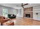 Inviting living room featuring hardwood floors, a brick fireplace, built-in bookcases, and natural light at 2592 River Oak Dr, Decatur, GA 30033
