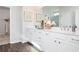 Bright bathroom featuring double sinks, white cabinets, and decorative accents at 417 Newland Way, Acworth, GA 30102