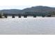 View of a green truss bridge over a body of water with mountains in the distance at 417 Newland Way, Acworth, GA 30102