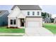 Charming two-story home with a white brick facade, a well-manicured lawn, and a two car garage at 417 Newland Way, Acworth, GA 30102