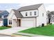 Charming two-story home with a white brick facade, a well-manicured lawn, and a two car garage at 417 Newland Way, Acworth, GA 30102