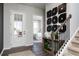 Elegant foyer featuring a light gray floor, staircase, stylish decor, and an open view to the main bedroom at 417 Newland Way, Acworth, GA 30102