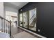 Elegant foyer featuring a dark accent wall, staircase, stylish decor, and an open view to the dining room at 417 Newland Way, Acworth, GA 30102