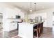 Bright kitchen features a large island, stainless appliances, modern pendant lighting, and white cabinetry at 417 Newland Way, Acworth, GA 30102