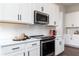 Modern kitchen showcases stainless steel appliances, sleek cooktop, white subway tile, and ample counter space at 417 Newland Way, Acworth, GA 30102