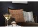 Close up of chaise lounge chair with a woven throw pillow in front of a black shiplap wall at 417 Newland Way, Acworth, GA 30102