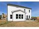 Rear of home with white siding, large windows, patio furniture, and a spacious yard at 417 Newland Way, Acworth, GA 30102