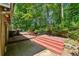The home's backyard features a multi-tiered deck for outdoor living and is surrounded by lush trees for added privacy at 475 Shadetree Ln, Lawrenceville, GA 30044