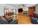 Open-concept living room with hardwood flooring, a fireplace, and built-in shelving at 475 Shadetree Ln, Lawrenceville, GA 30044