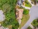 Bird's-eye view of a home featuring a unique roof design, surrounded by lush trees, and a spacious lawn at 600 Oakmont Hl, Duluth, GA 30097