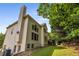 Two-story home featuring a prominent chimney and a deck, surrounded by mature trees and greenery at 600 Oakmont Hl, Duluth, GA 30097