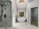 Bright primary bathroom featuring walk-in shower, soaking tub, and walk-in closet at 600 Oakmont Hl, Duluth, GA 30097