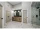 Beautiful primary bathroom with double vanity and walk-in shower with glass doors at 600 Oakmont Hl, Duluth, GA 30097
