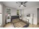 Modern bedroom with a platform bed, makeup vanity, and ample natural light from two windows at 600 Oakmont Hl, Duluth, GA 30097