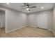 Bright bedroom featuring hardwood floors, modern ceiling fan, and double door closet at 600 Oakmont Hl, Duluth, GA 30097
