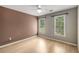 Bright bedroom with neutral tones, hardwood floors, ceiling fan and natural light at 600 Oakmont Hl, Duluth, GA 30097