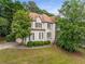 Charming two-story home featuring a well-manicured front yard and a classic design with beautiful landscaping at 600 Oakmont Hl, Duluth, GA 30097